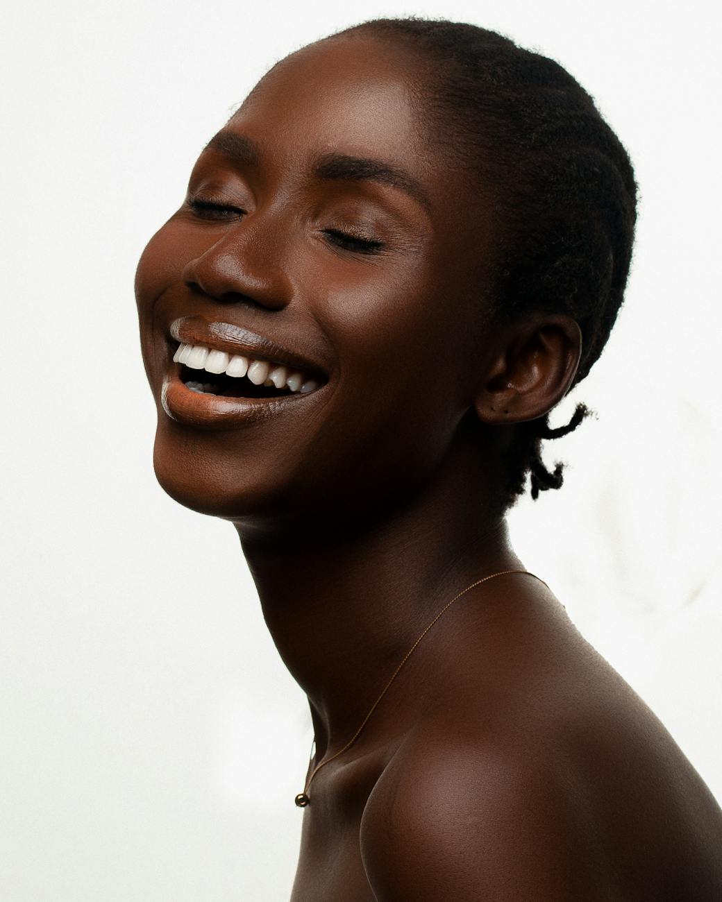 Elegant portrait of a smiling woman with radiant skin in Lagos. Captures beauty and warmth.