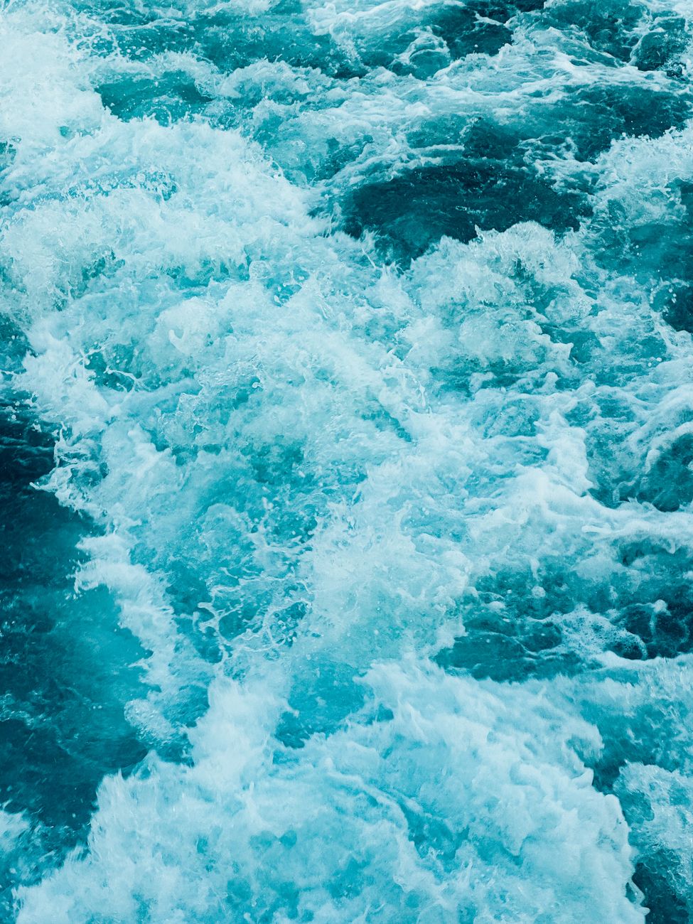Vibrant ocean waves captured in motion, showcasing foam and energy.