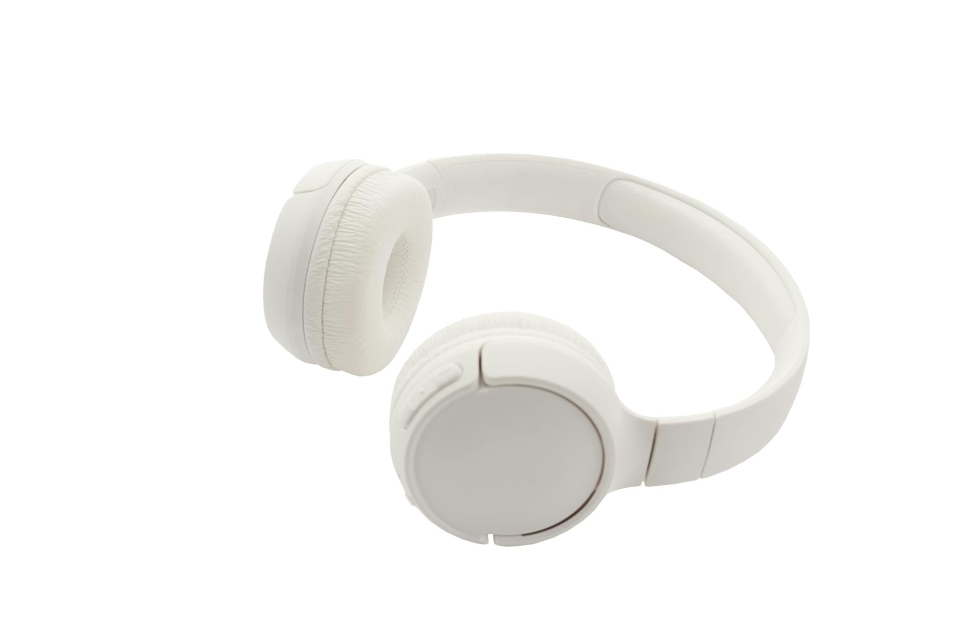 Sleek white wireless headphones against a white backdrop, showcasing minimalist design and modern technology.