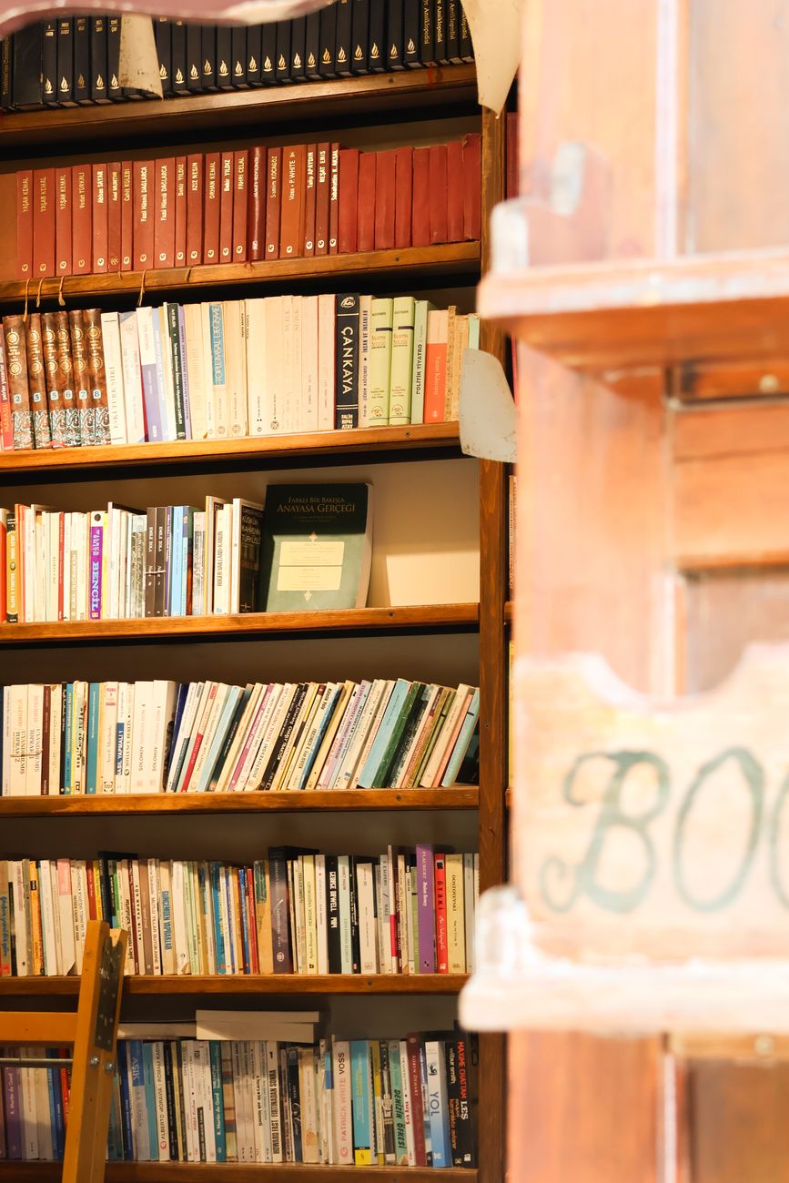 Warm and inviting library with wooden bookshelves filled with books. Ideal for study or relaxation.