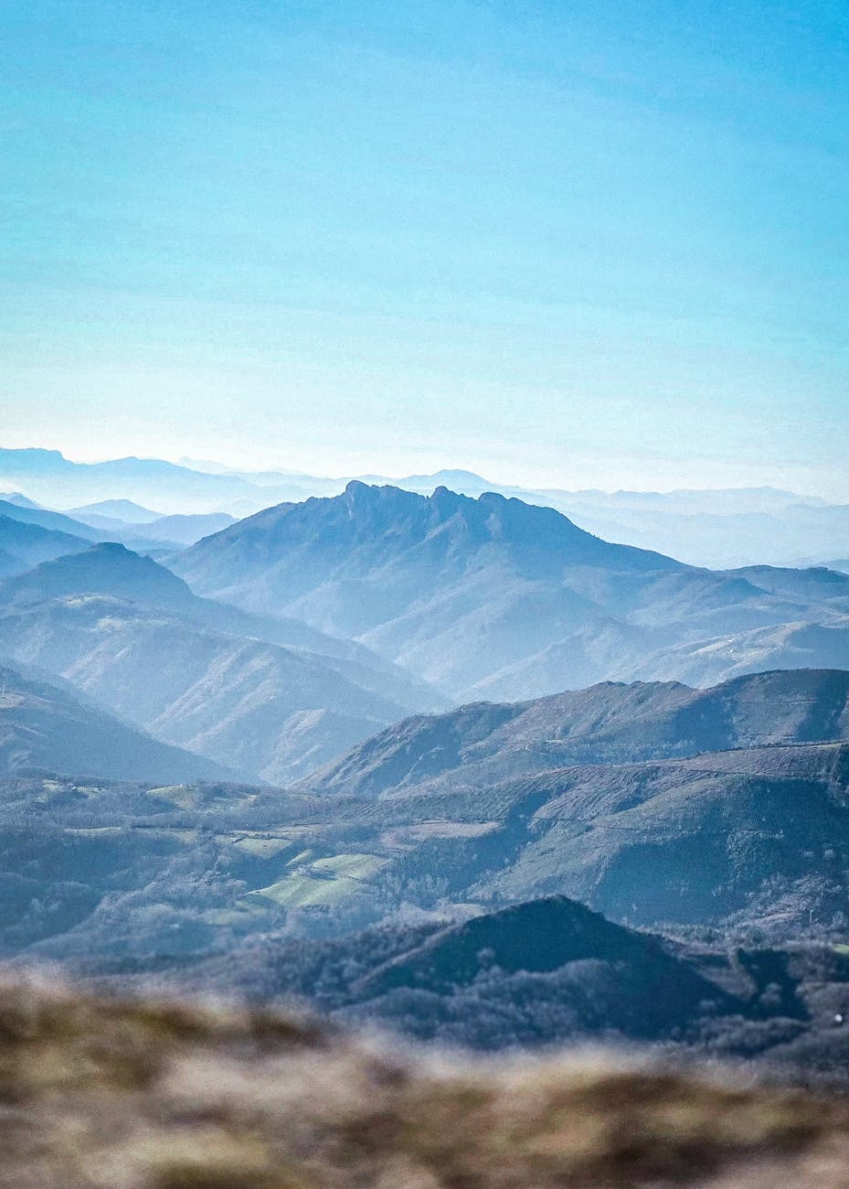 Captivating landscape of the Pyrenees with rolling hills and blue hues.