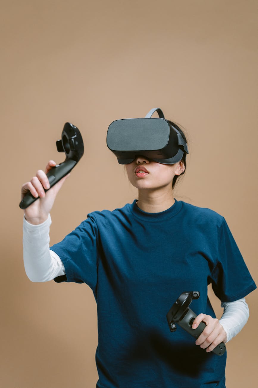 Young woman wearing VR headset and using controllers for an immersive virtual reality experience on a beige background.
