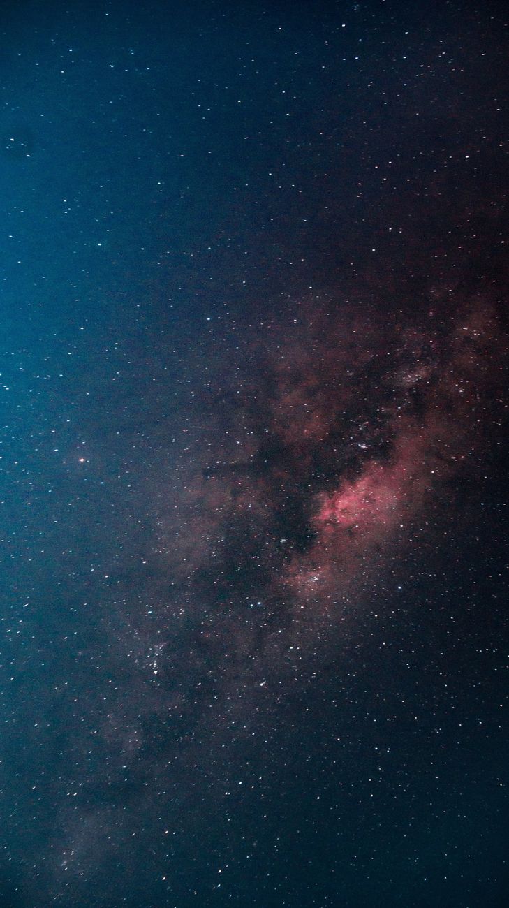 A breathtaking vertical shot of the Milky Way galaxy illuminating the dark night sky.