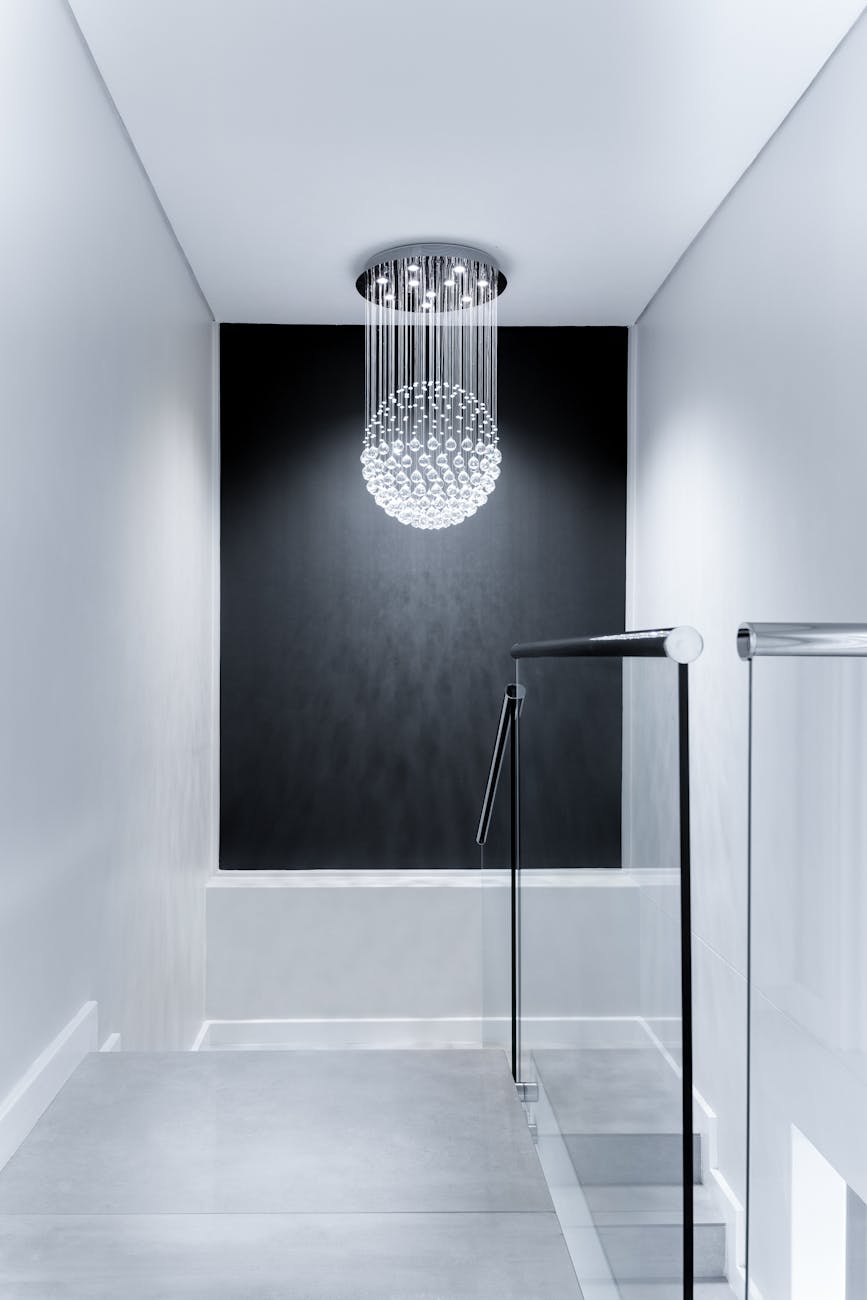 Sleek contemporary hallway featuring a stunning glass chandelier and minimalist design.