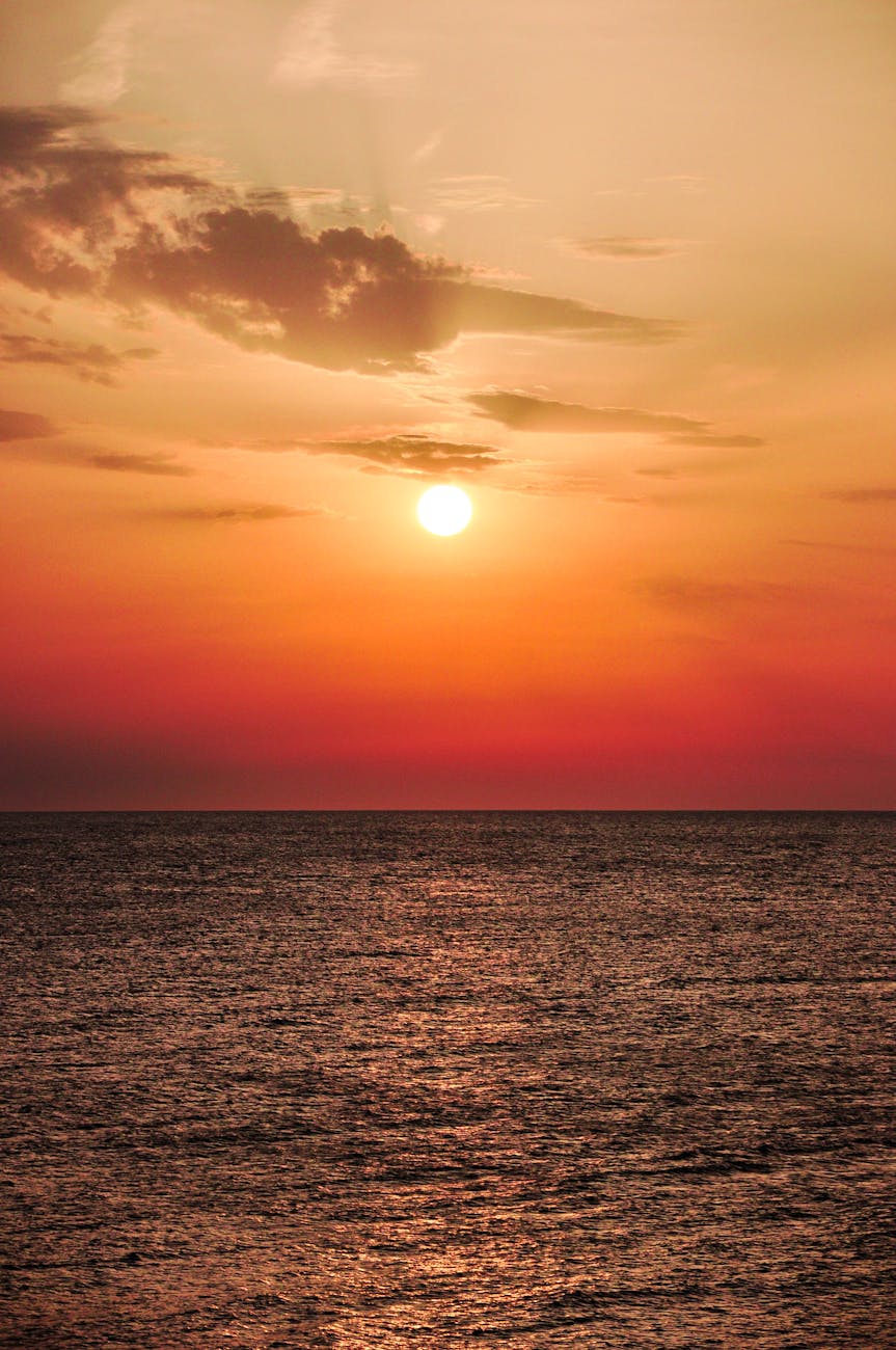 A breathtaking ocean sunset casting warm colors across the horizon.