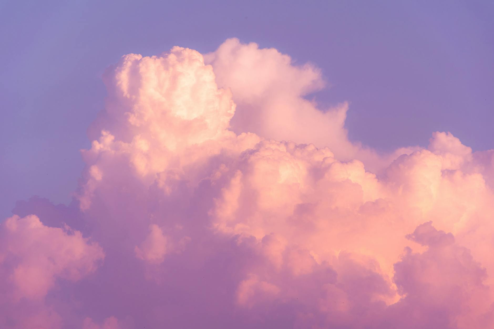 Beautiful pastel clouds illuminated by sunset colors, creating a dreamy sky.