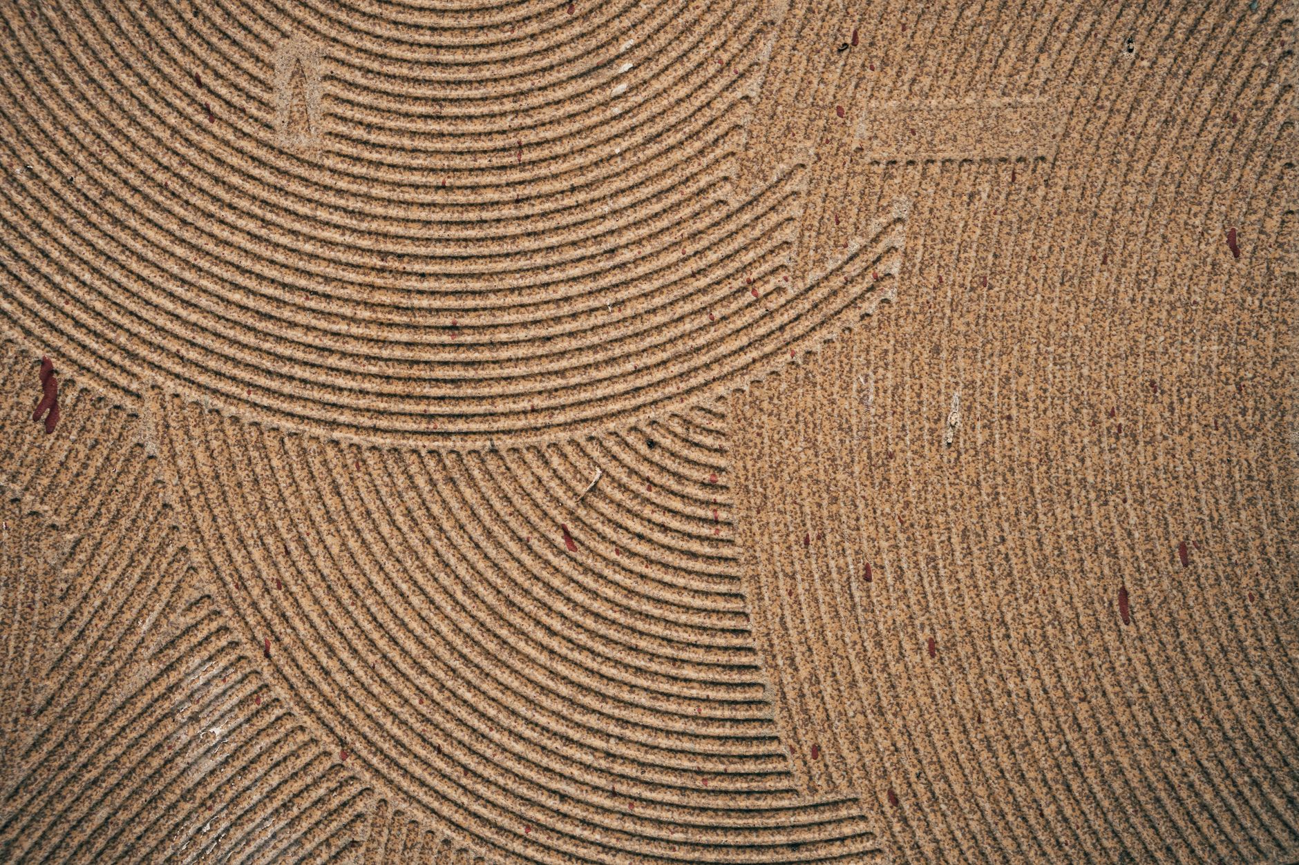 Close-up of a coir mat showcasing intricate circular patterns and texture details.