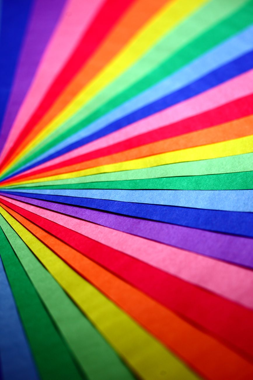 Colorful abstract composition of overlapping rainbow papers creating a vibrant spectrum.