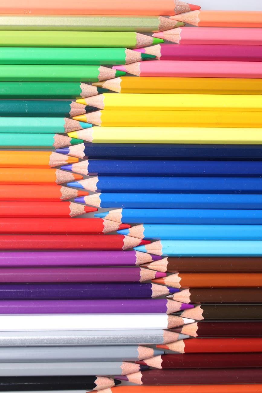 Colorful and organized colored pencils forming a vivid pattern. Perfect for creative projects or artistic inspiration.