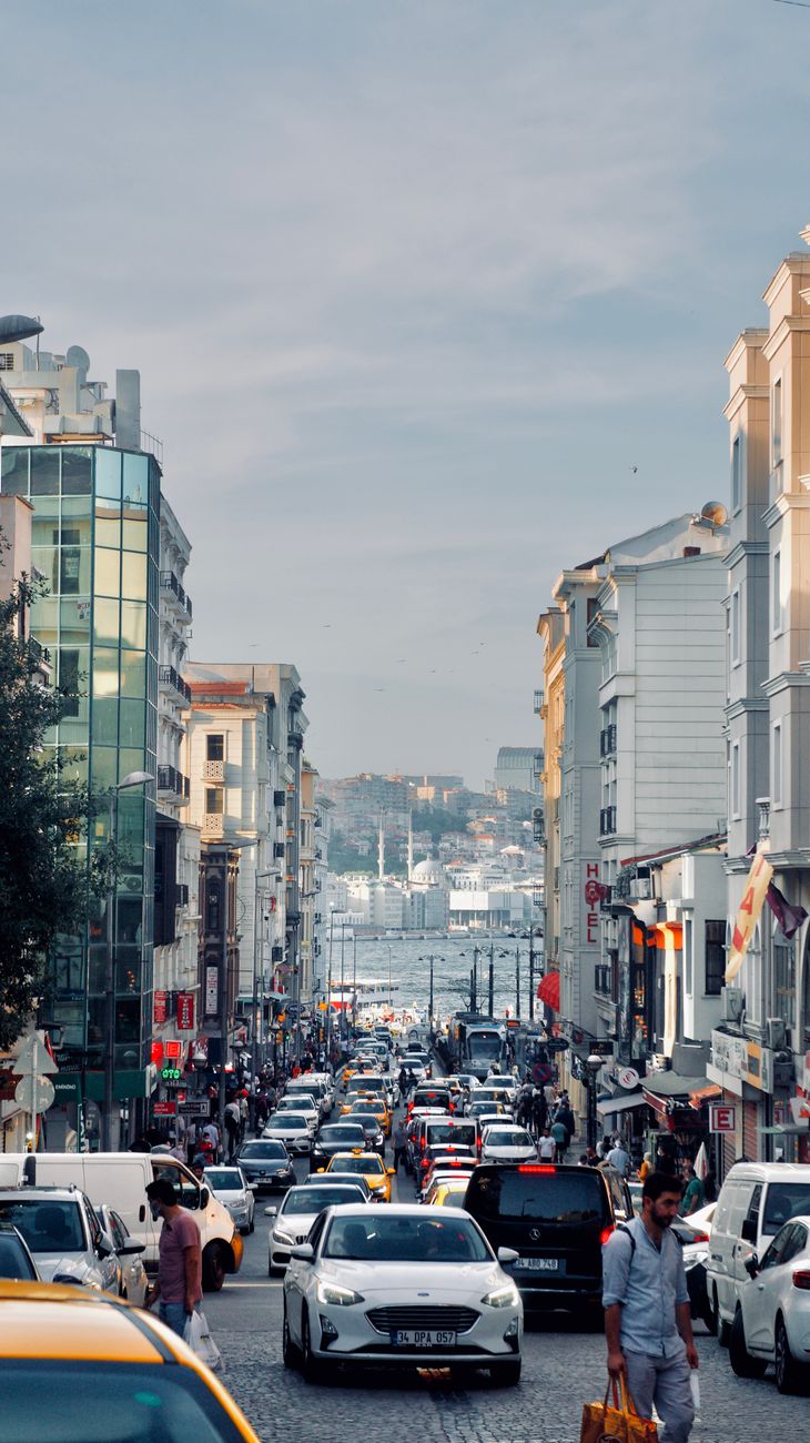 A vibrant street in Istanbul with traffic, showcasing urban life and architectural diversity.