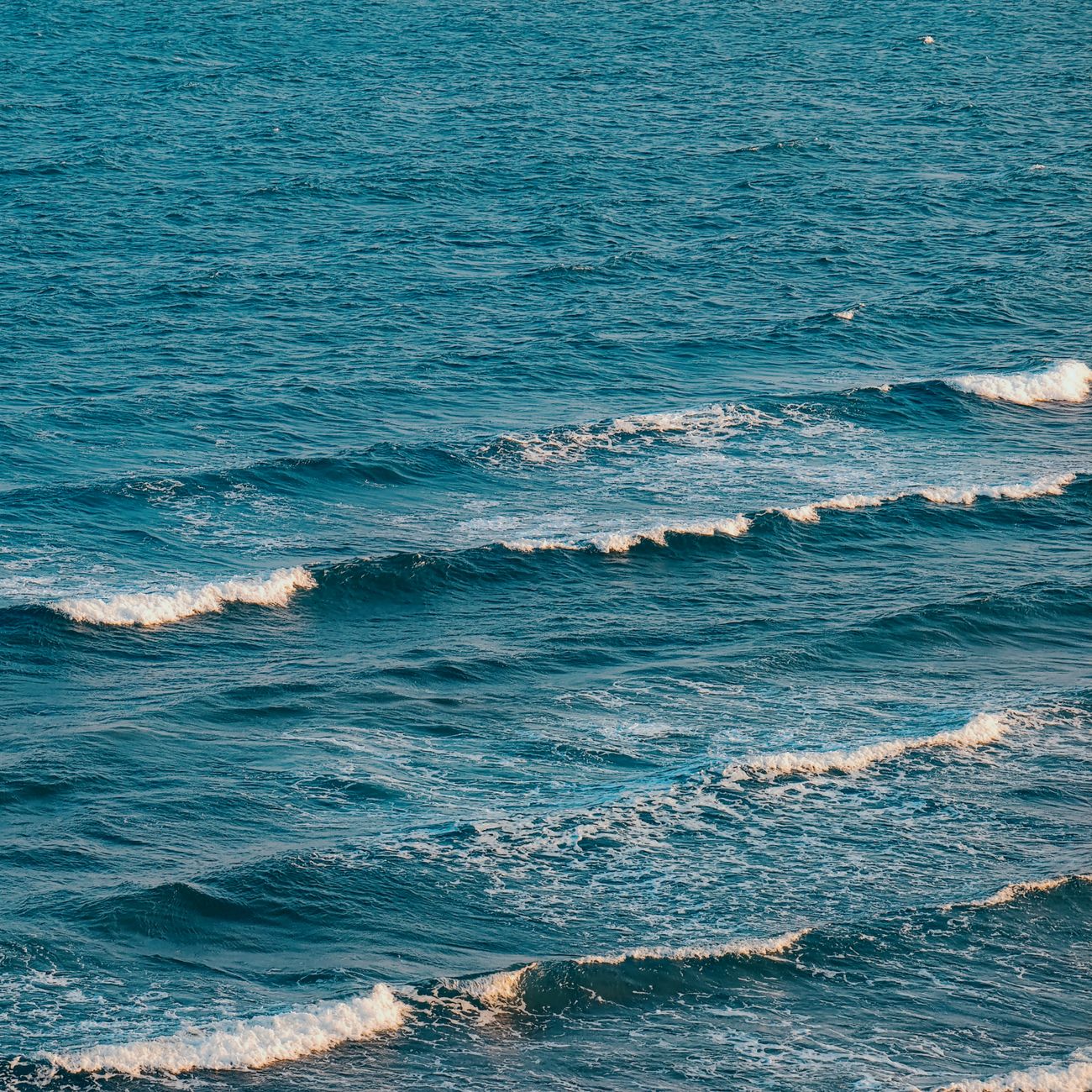 Gentle waves form a serene pattern off the coast of Phan Rang, Vietnam, embodying the calm beauty of the ocean.