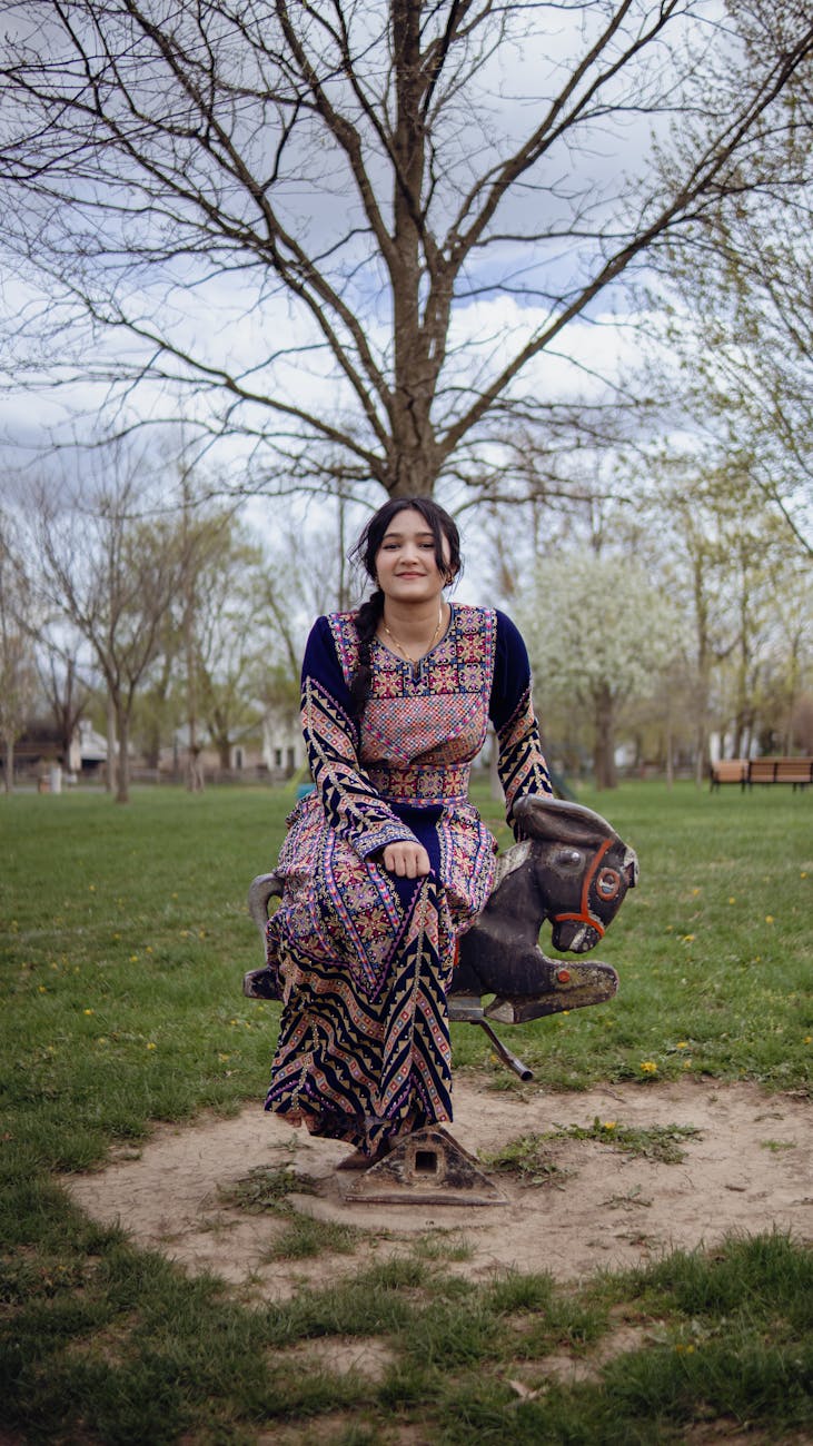 A smiling woman in traditional dress enjoying a ride in a spring park in London, Ohio.