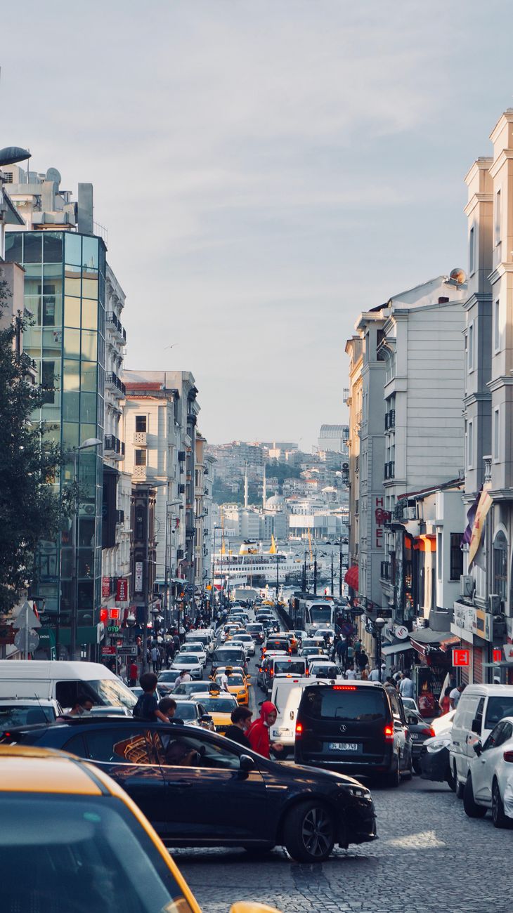 View of a busy Istanbul street filled with cars and people on a sunny day.