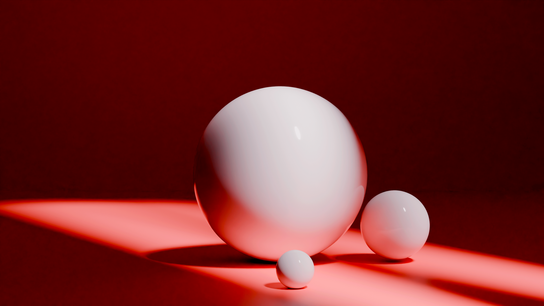 Minimalist composition of three white spheres on a bold red background.