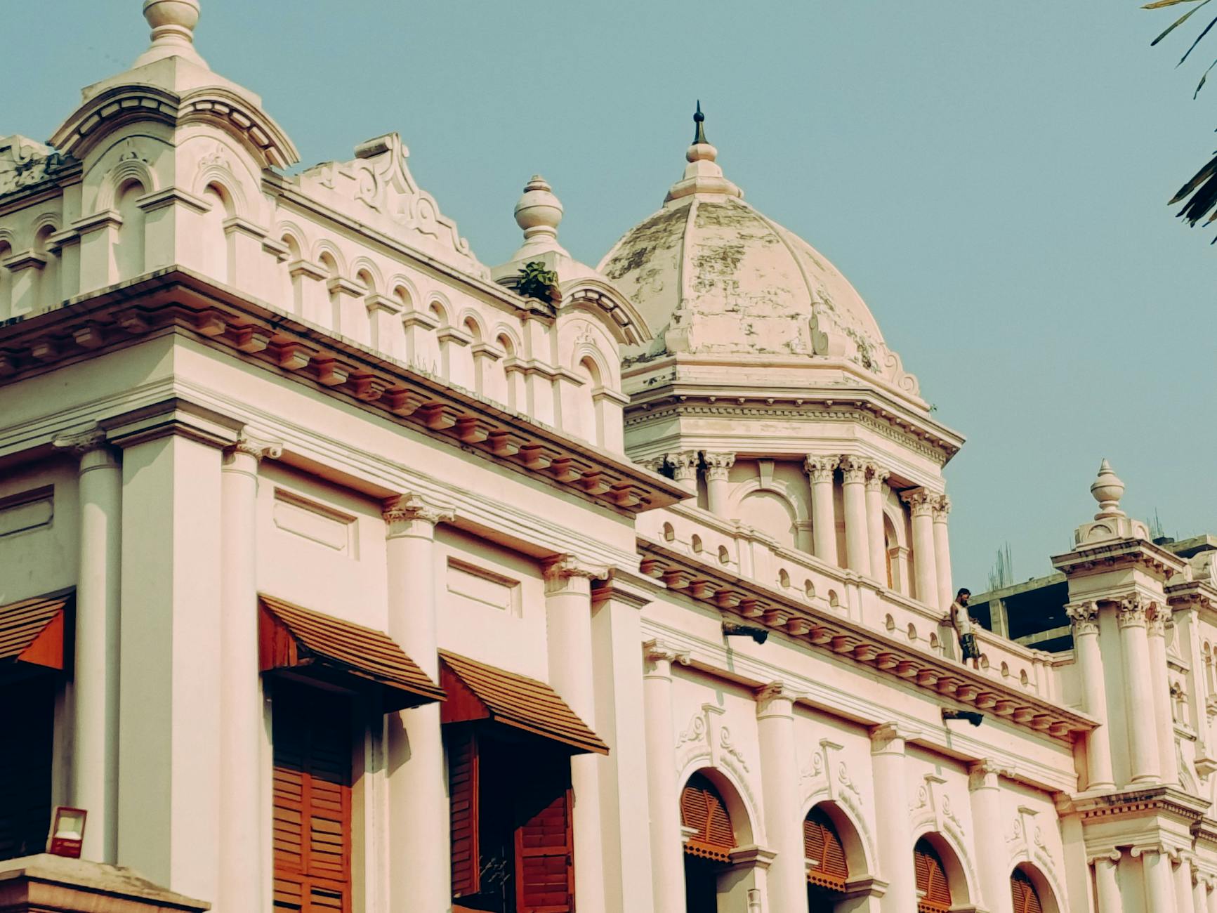 Elegant historic building with dome under clear sky. Classical design showcasing architectural beauty.