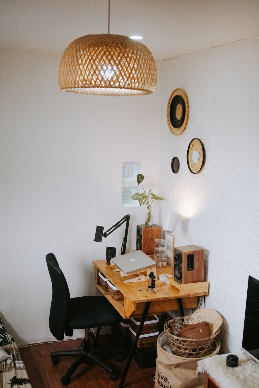 Comfortable home office setup featuring a wooden desk with stylish decor elements.