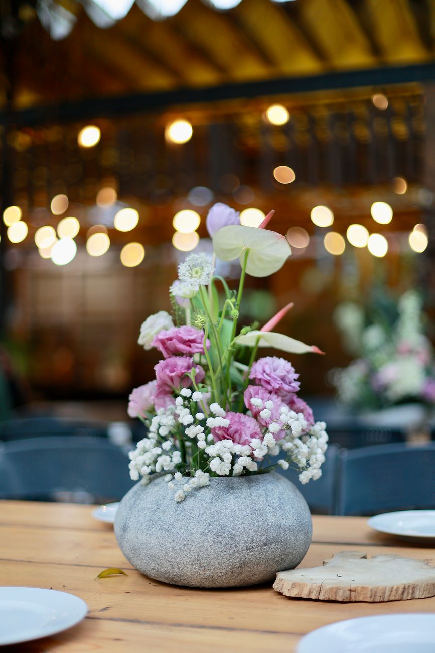 Beautiful floral arrangement on a rustic table, perfect for weddings.