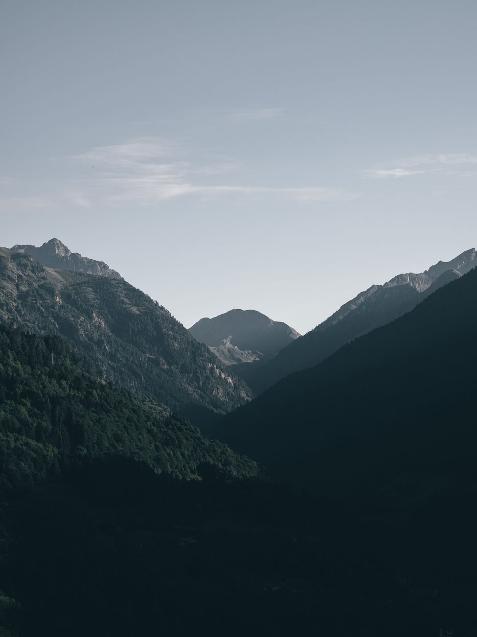 Tranquil mountain range under a blue sky, perfect for nature backgrounds.