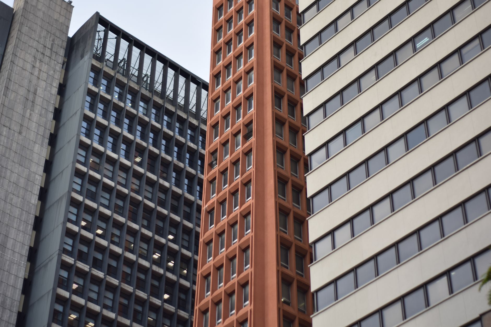 Close-up of modern skyscrapers with diverse architectural styles and glass facades.
