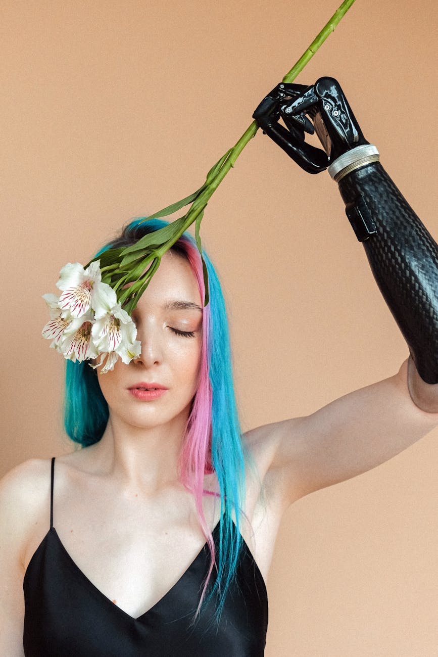 A captivating portrait of a woman with a prosthetic arm holding flowers, showcasing beauty and resilience.