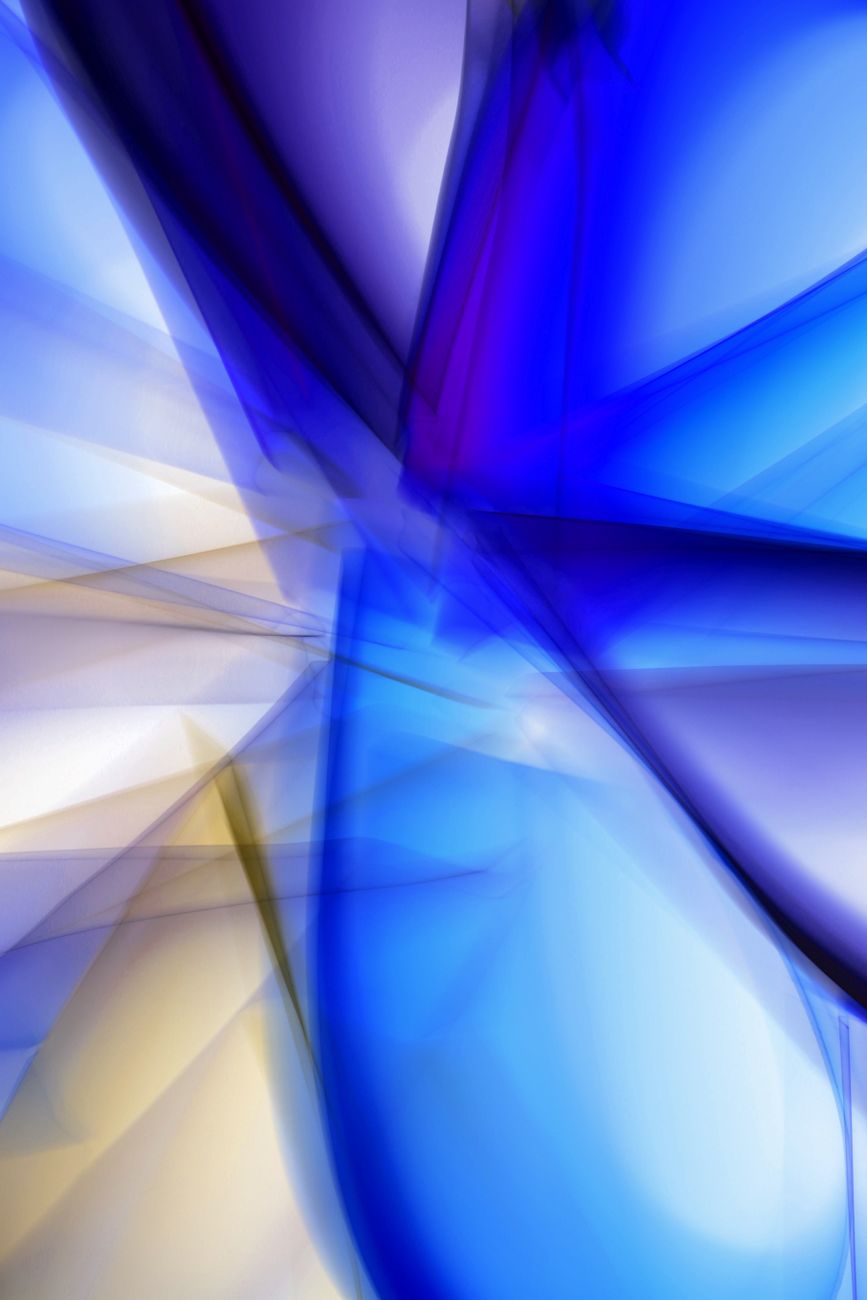 Dynamic abstract art with vibrant blue and yellow light streaks creating a sense of movement and energy.