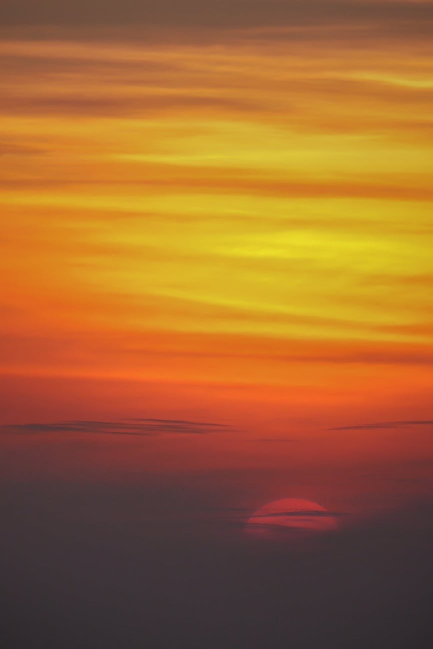 Capture of a vibrant sunset sky with bold reds, oranges, and yellows creating a dramatic and breathtaking view.