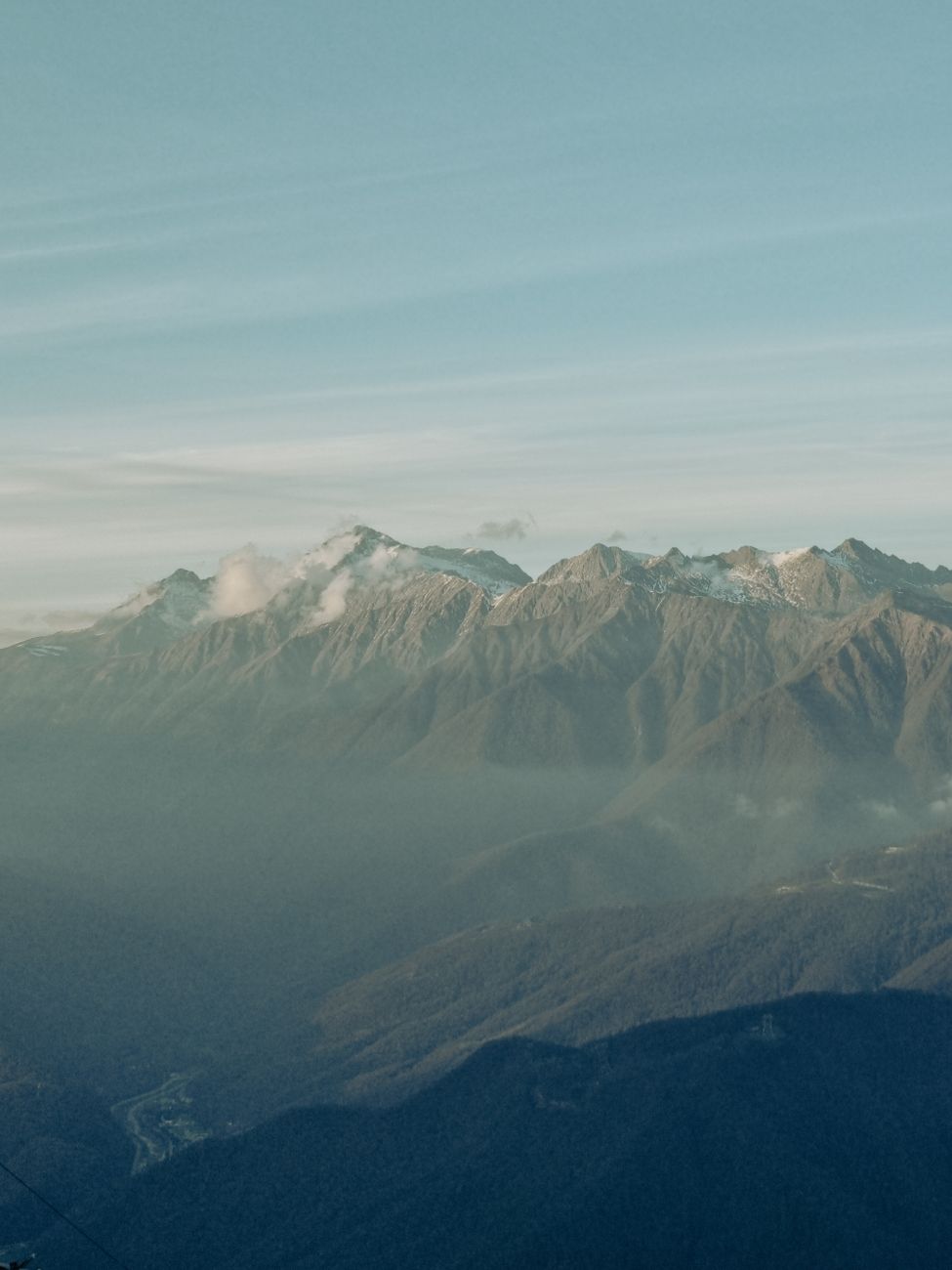 Breathtaking view of the snow-capped mountains in Sochi, Russia, under a clear sky. Perfect for nature enthusiasts.