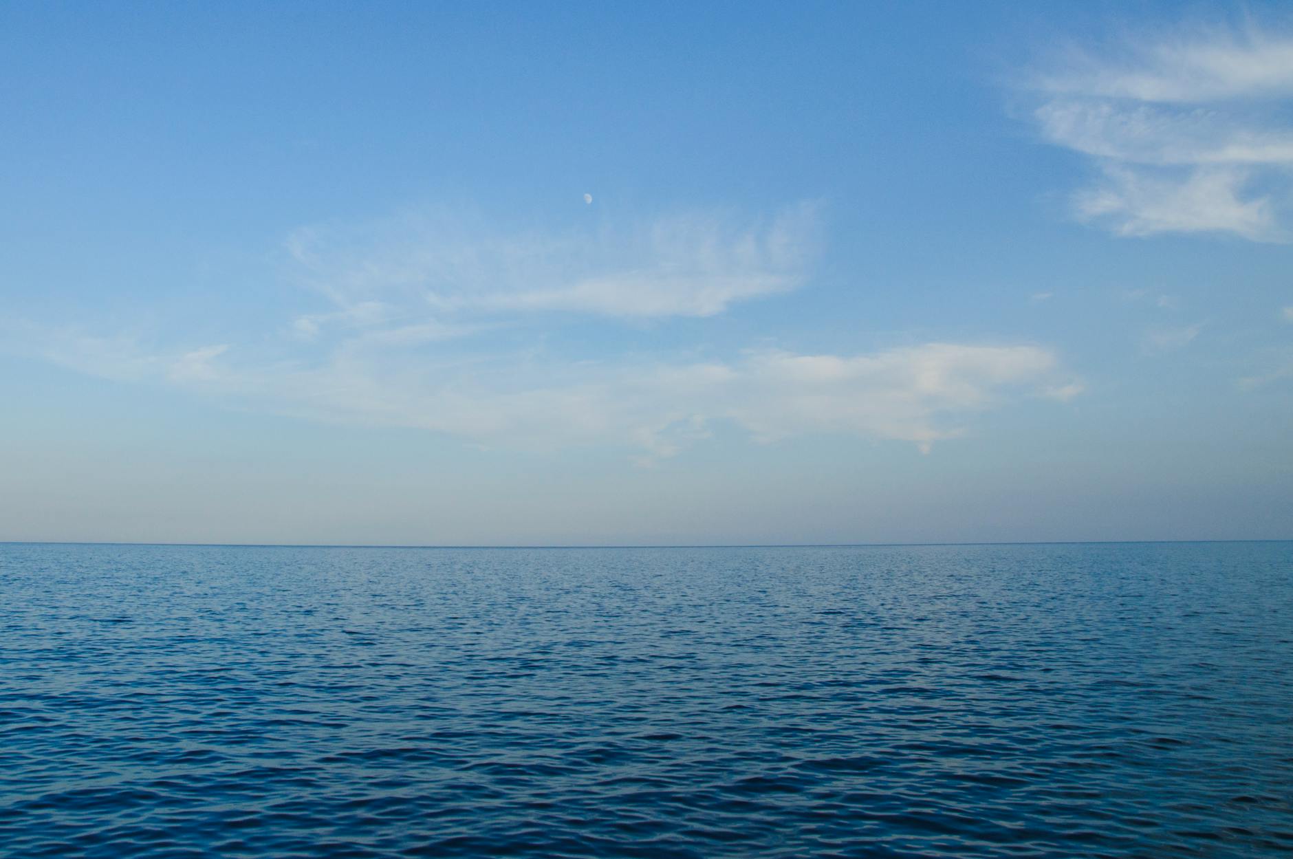 Calm ocean view with clear blue sky, perfect for backgrounds or wallpapers.