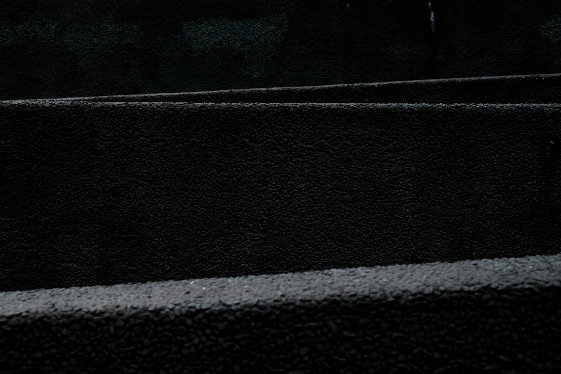 A dark and minimalist black texture pattern ideal for backgrounds and design use.