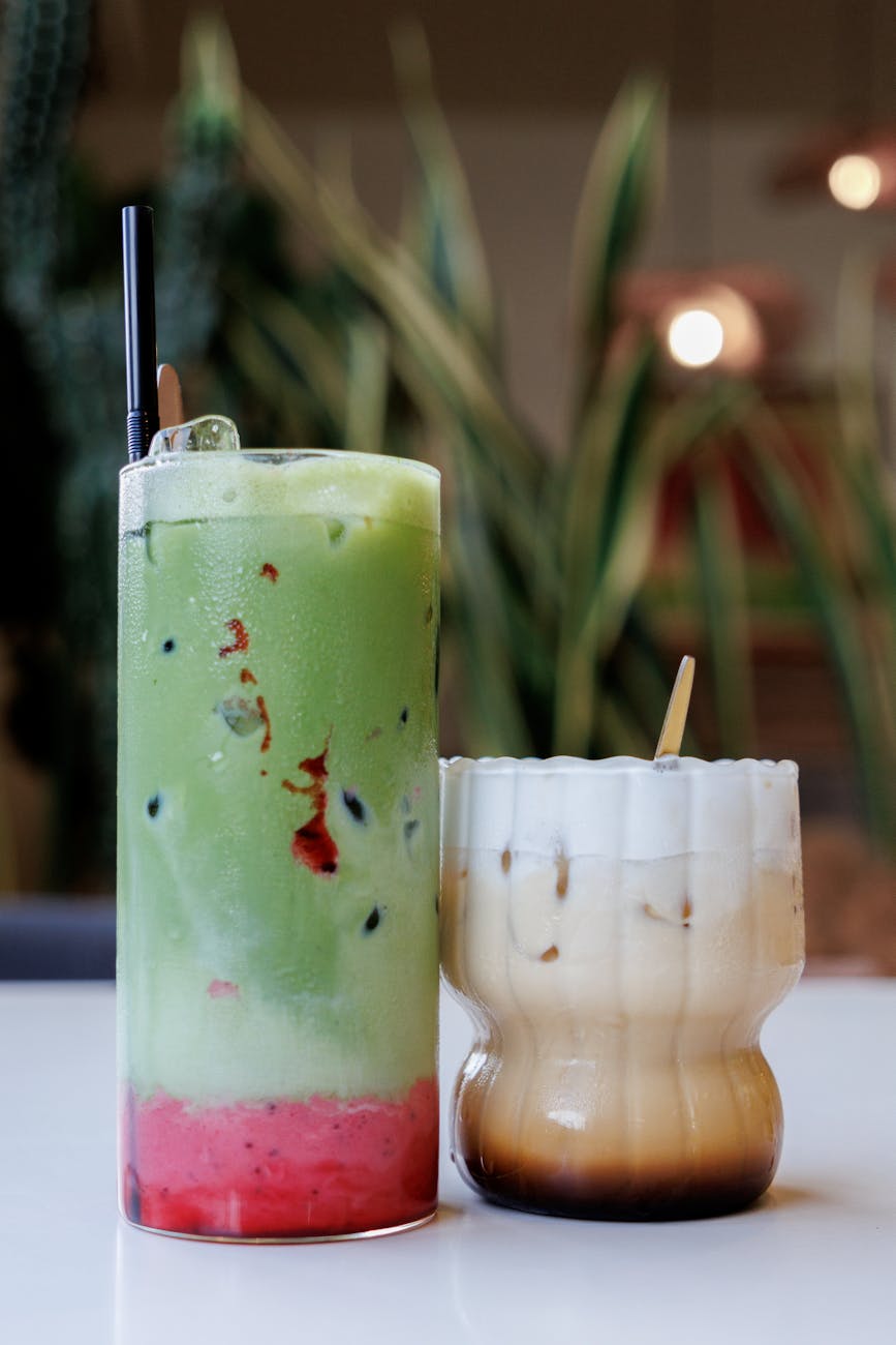 Two delicious beverages: iced matcha with berries and creamy iced coffee.