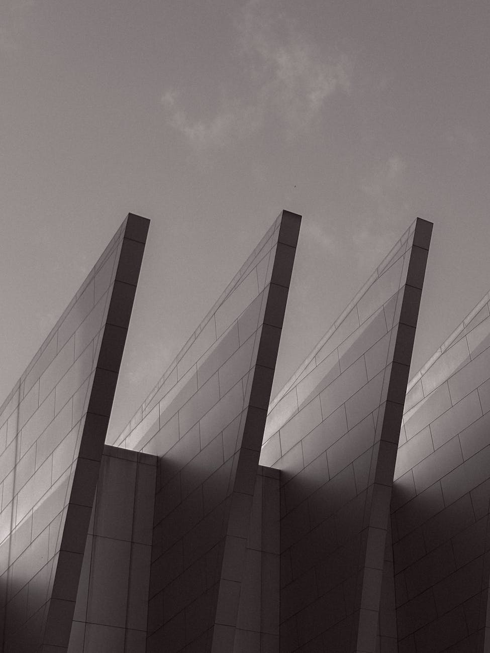 Black and white abstract photo capturing modern steel architecture with striking angles.