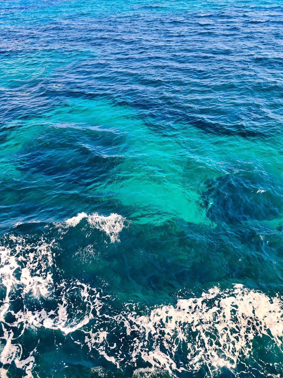 A serene view of the vibrant blue ocean with waves, evoking tranquility and nature's beauty.