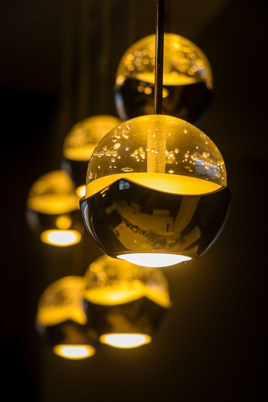 Warm indoor ambiance created by elegant hanging decorative lamps with a glowing effect.