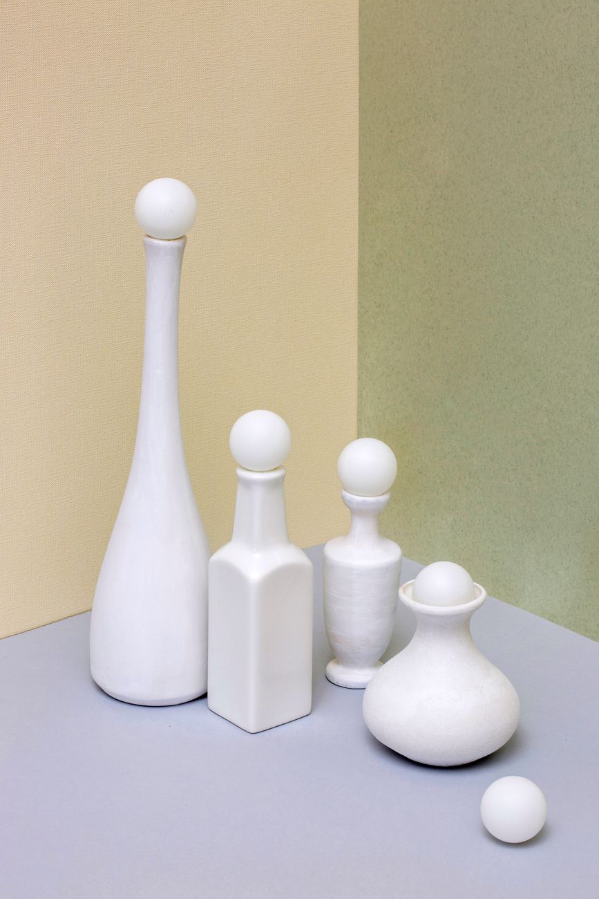 Elegant still life featuring white ceramic vases with unique shapes, showcasing minimalist design and composition.