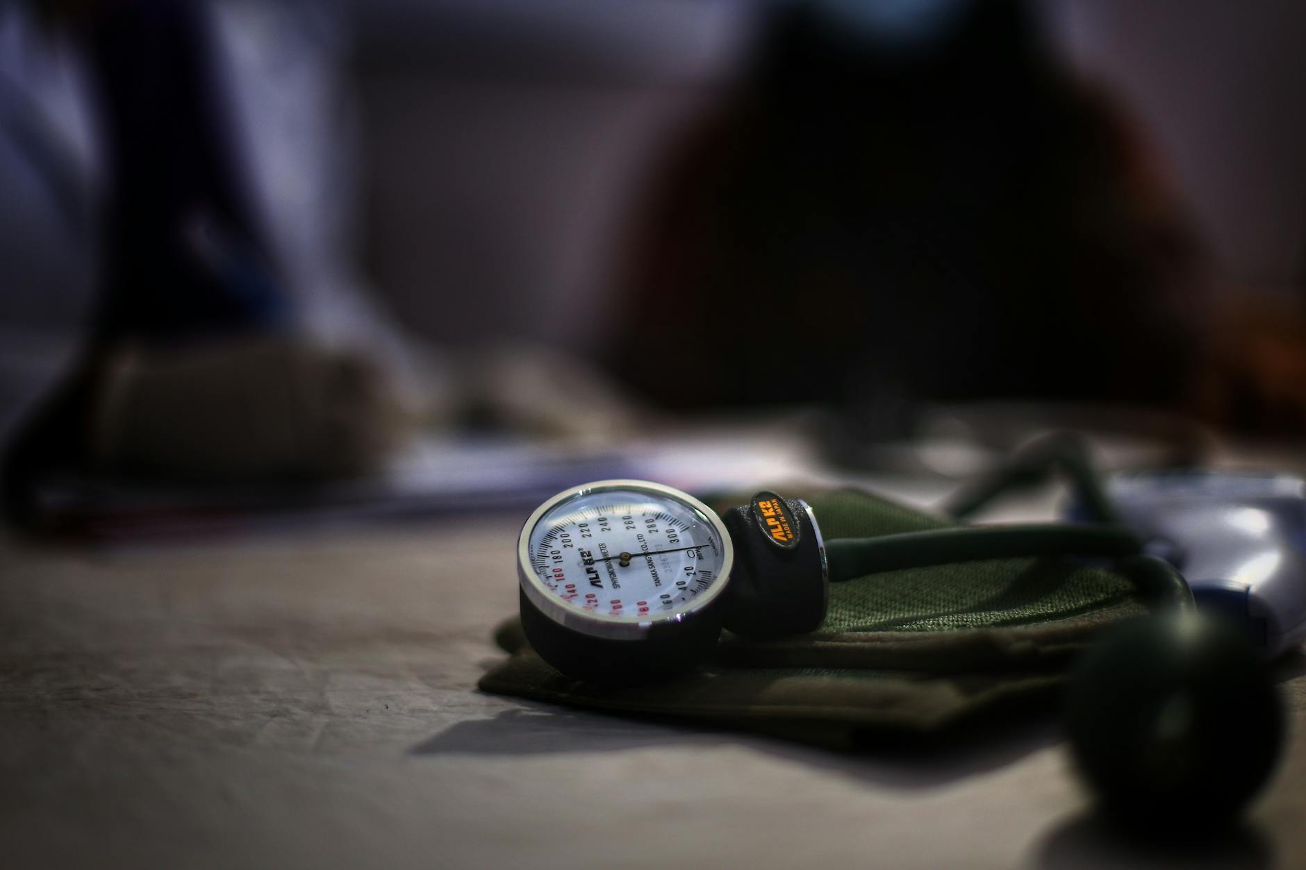 Detailed image of a medical sphygmomanometer on a table, indicating health check-up setting.