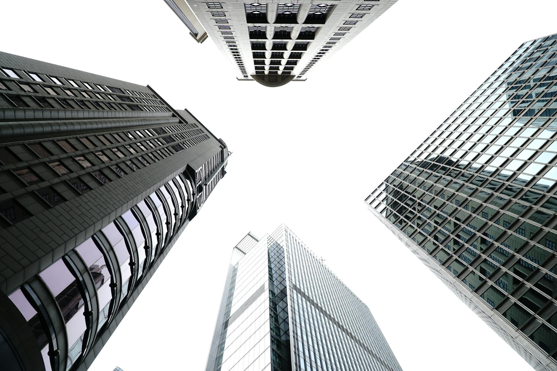 Low angle view of skyscrapers against a bright sky showcasing modern architecture.