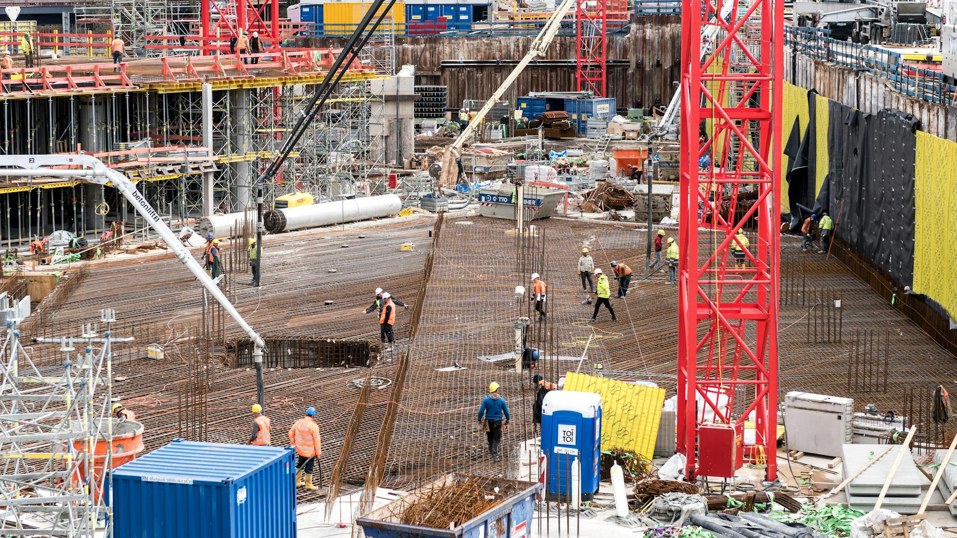 A bustling construction site in Hamburg with workers and equipment actively engaged in building tasks.