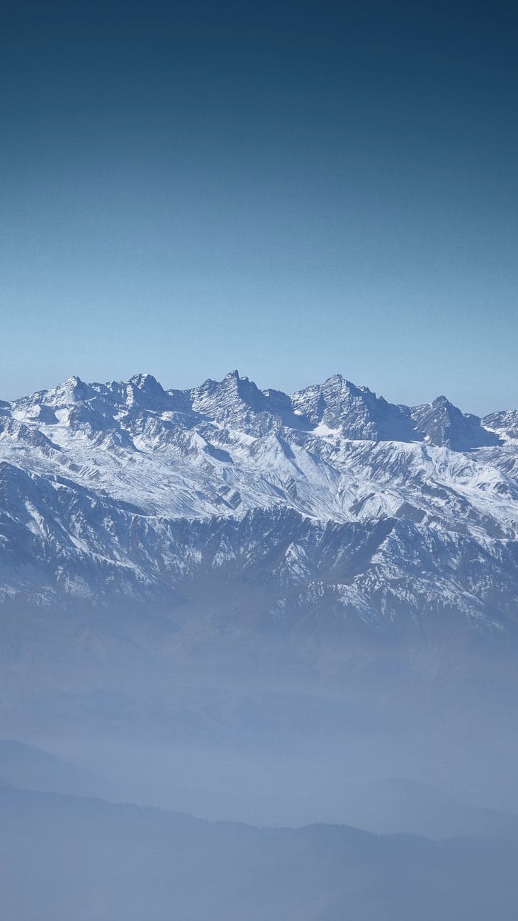 Breathtaking view of a snow-covered mountain range under a clear blue sky.