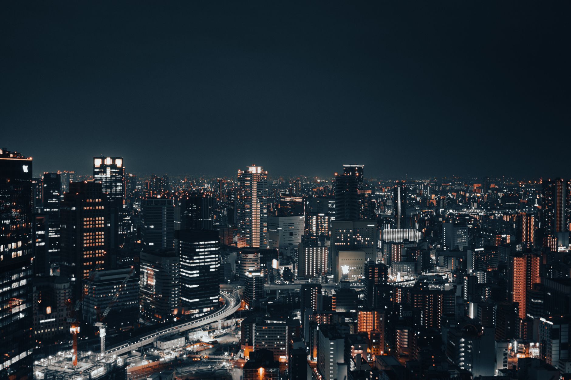 A captivating nighttime cityscape showcasing a vibrant urban skyline with illuminated buildings.