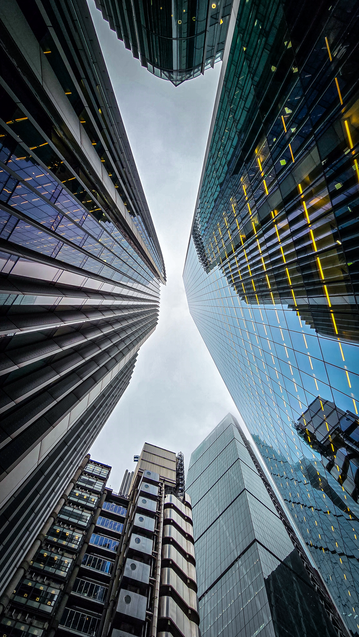 Upward view of modern skyscrapers in London, England showcasing urban architecture.