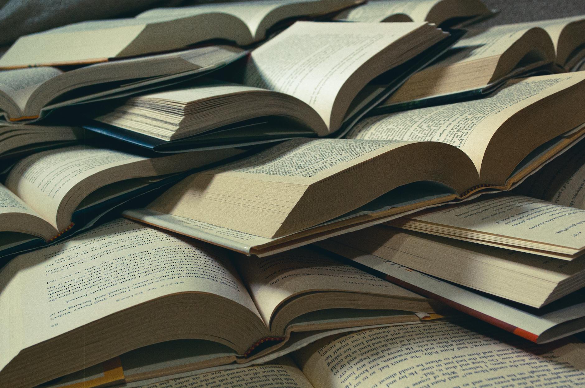 A close-up view of a pile of open books, perfect for bookworms and study sessions.