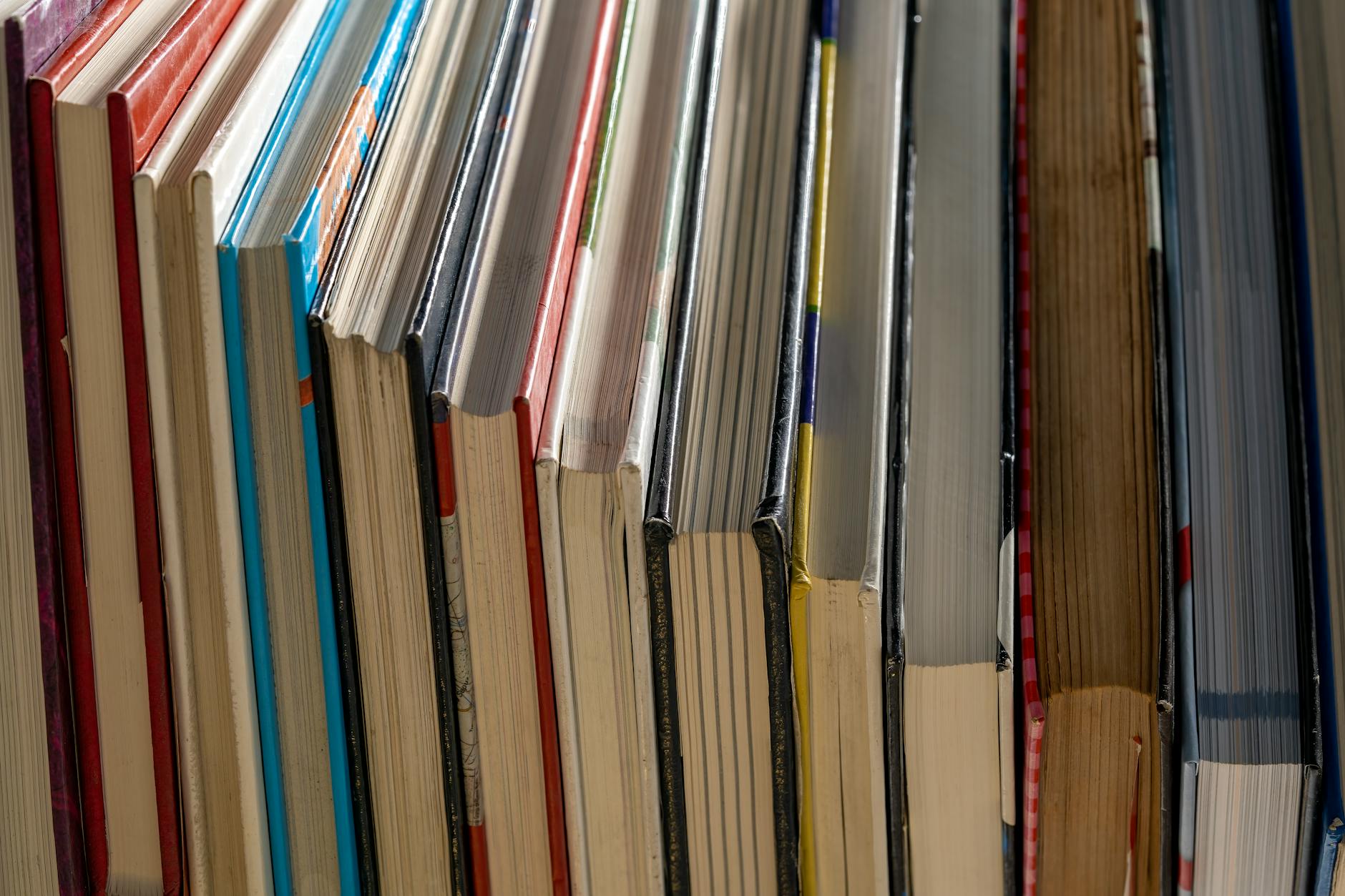 Vertical alignment of colorful book spines in a library. Ideal for study and education themes.
