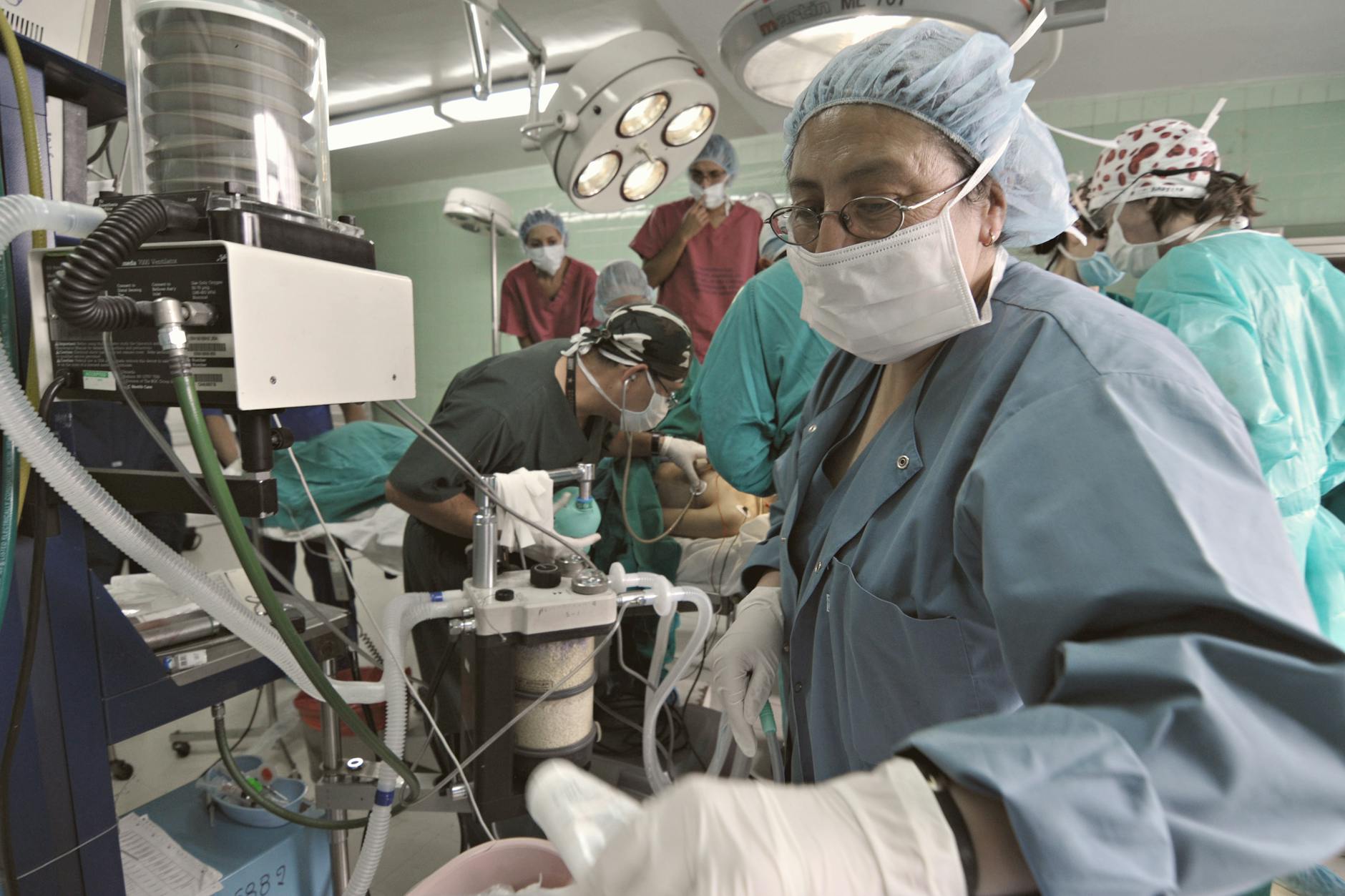 Busy surgical team operating in a hospital theatre, focusing on precision and teamwork.