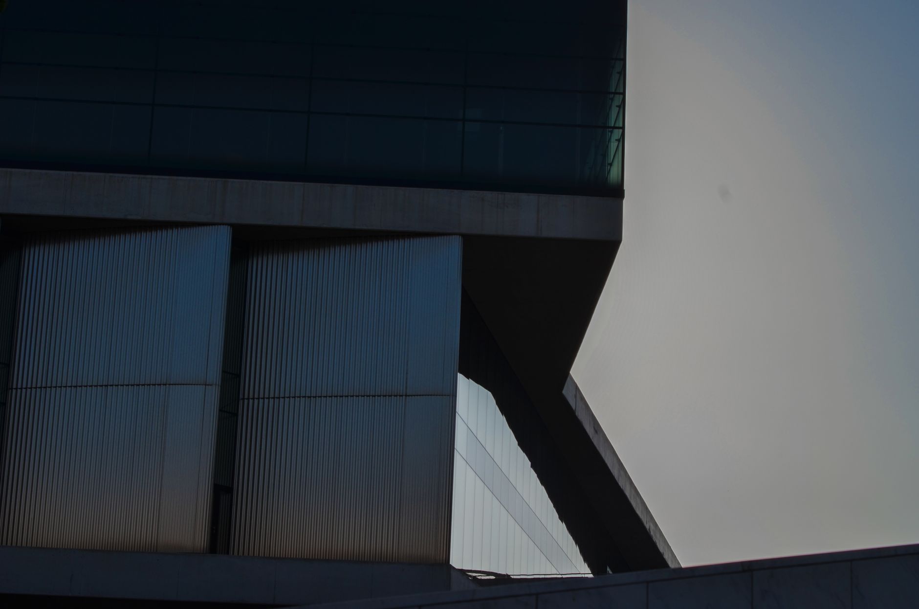 Contemporary building with glass and angles in Athens, Greece at twilight.
