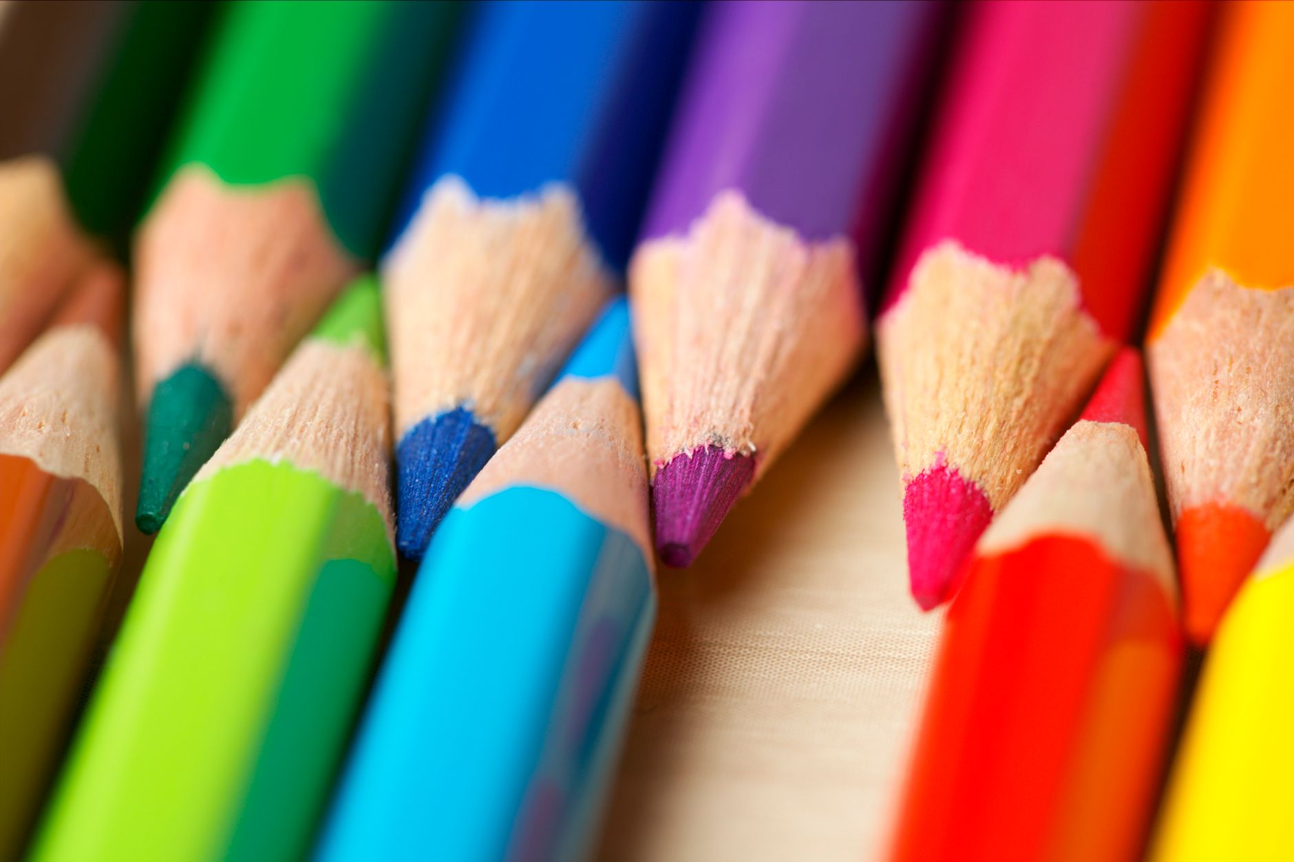 A detailed close-up image of colorful pencils arranged in a vibrant and harmonious pattern.