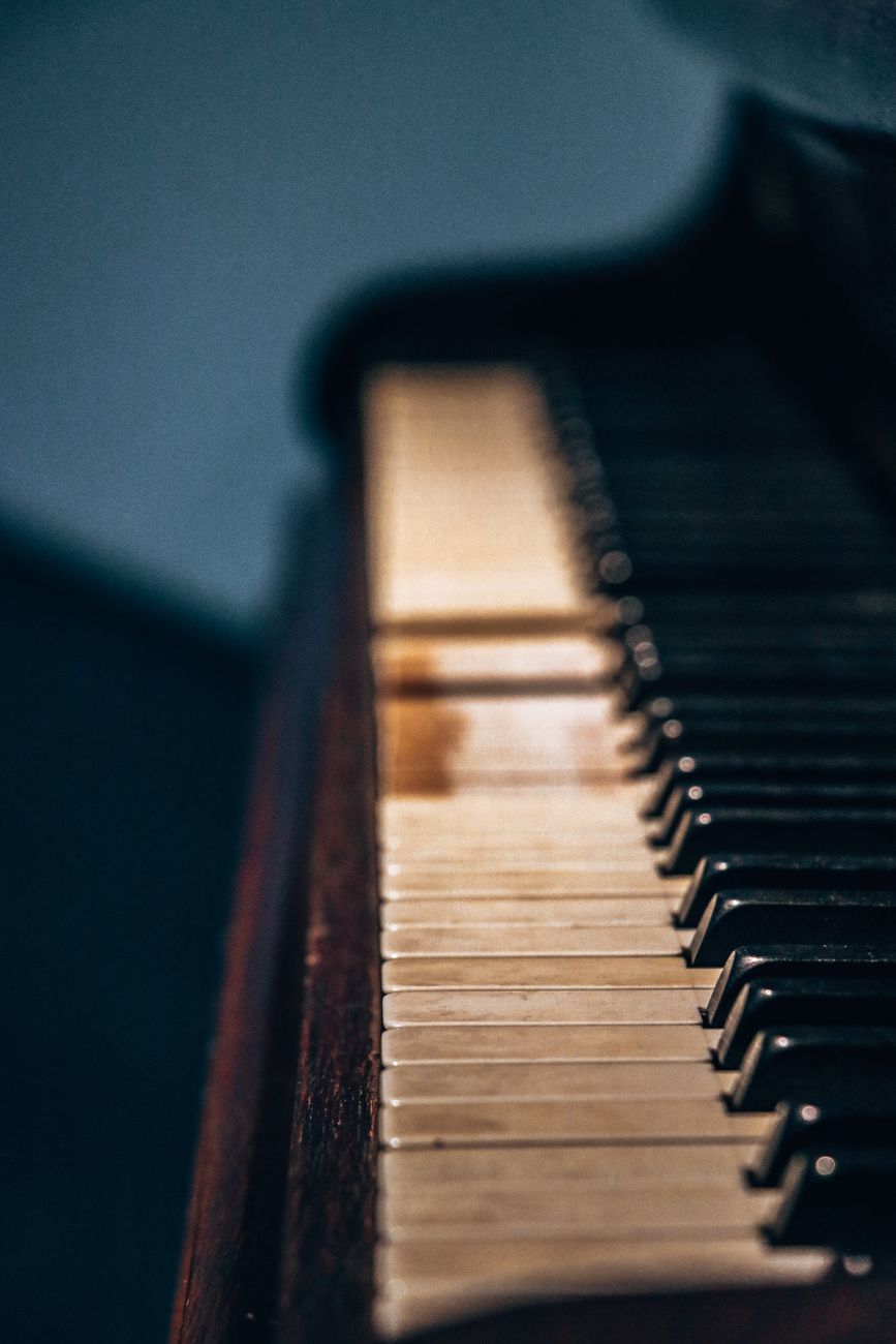 Detailed close-up of vintage piano keys, capturing the texture and atmosphere of a classic instrument.