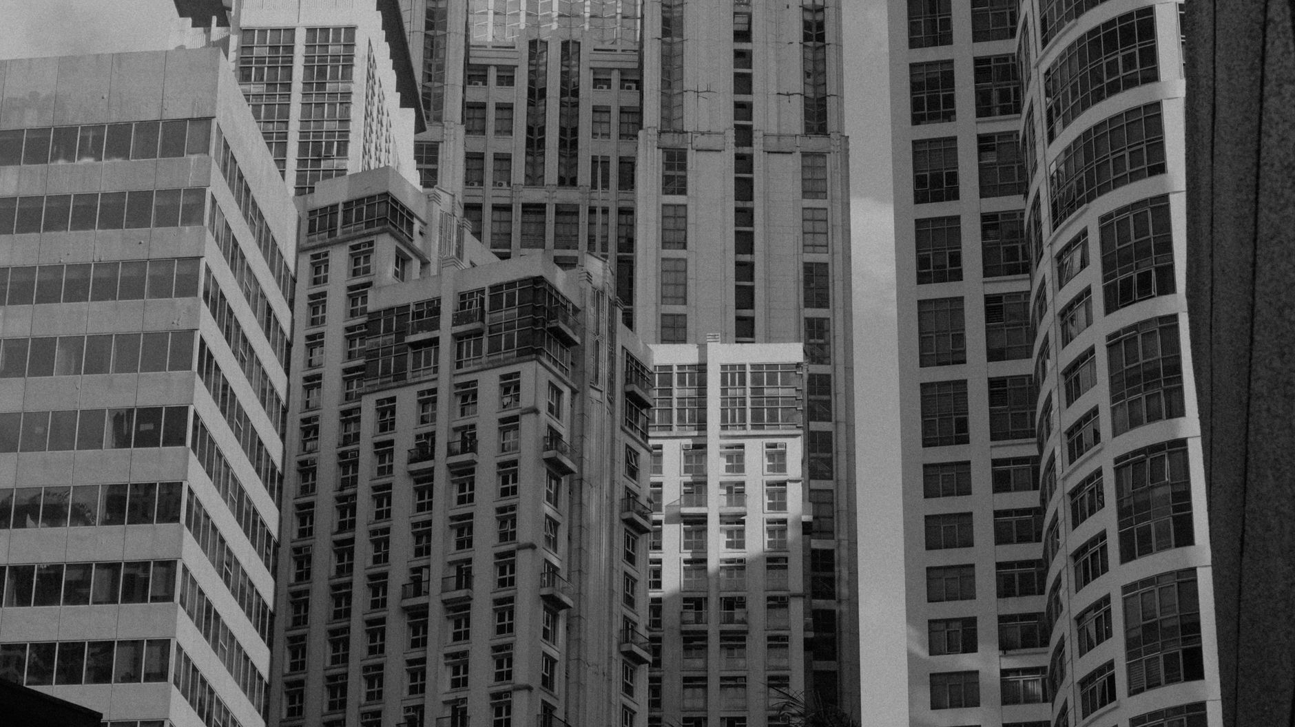 An artistic black and white cityscape showcasing modern skyscrapers' architectural details.