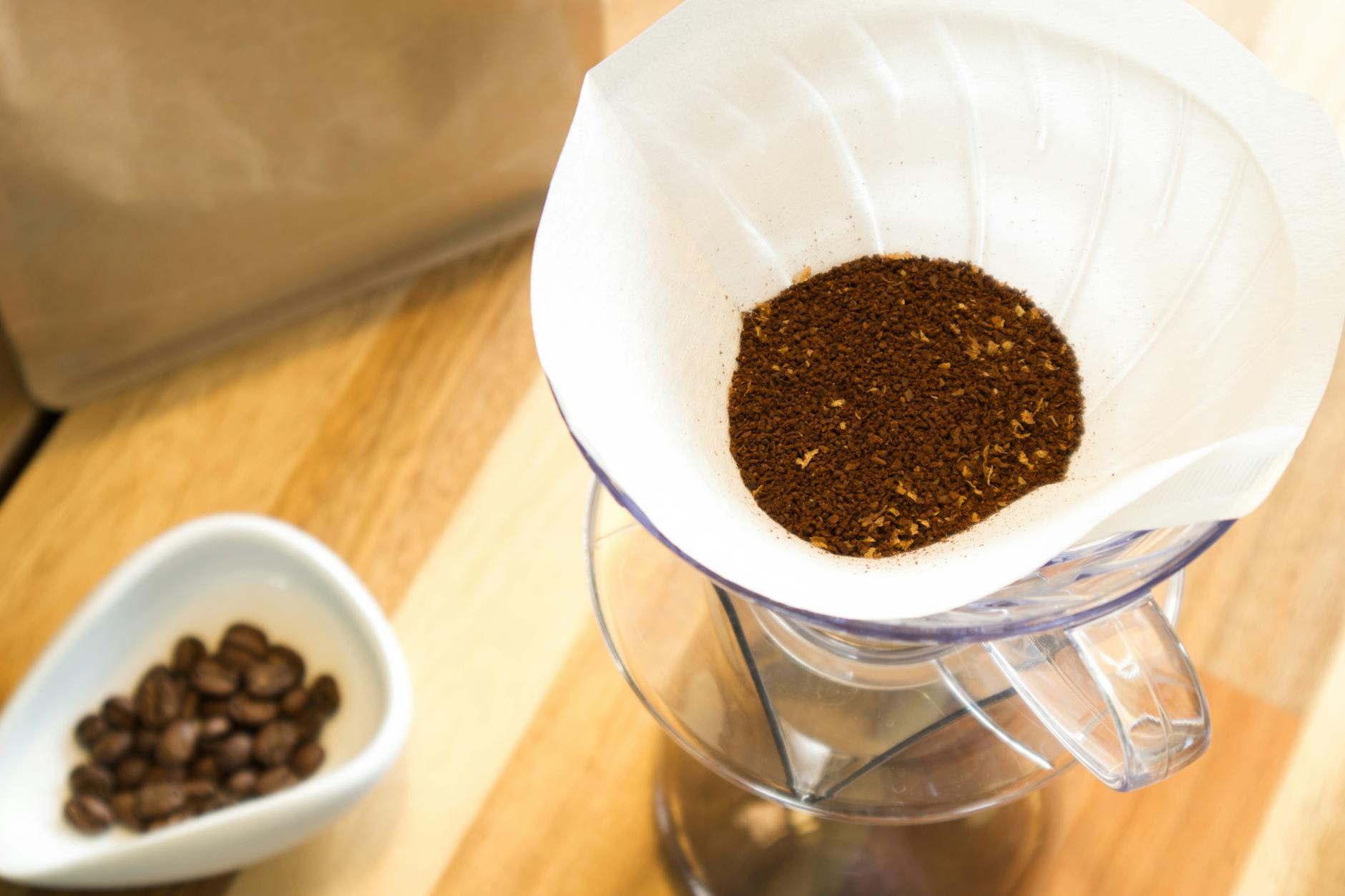 Overhead view of a V60 coffee dripper with coffee grounds ready for brewing.
