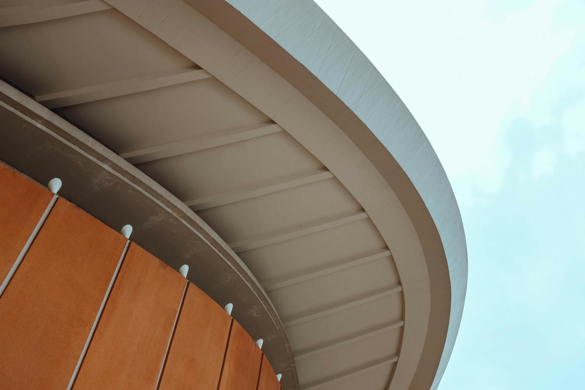 Abstract view of modern architectural building exterior with curved lines.