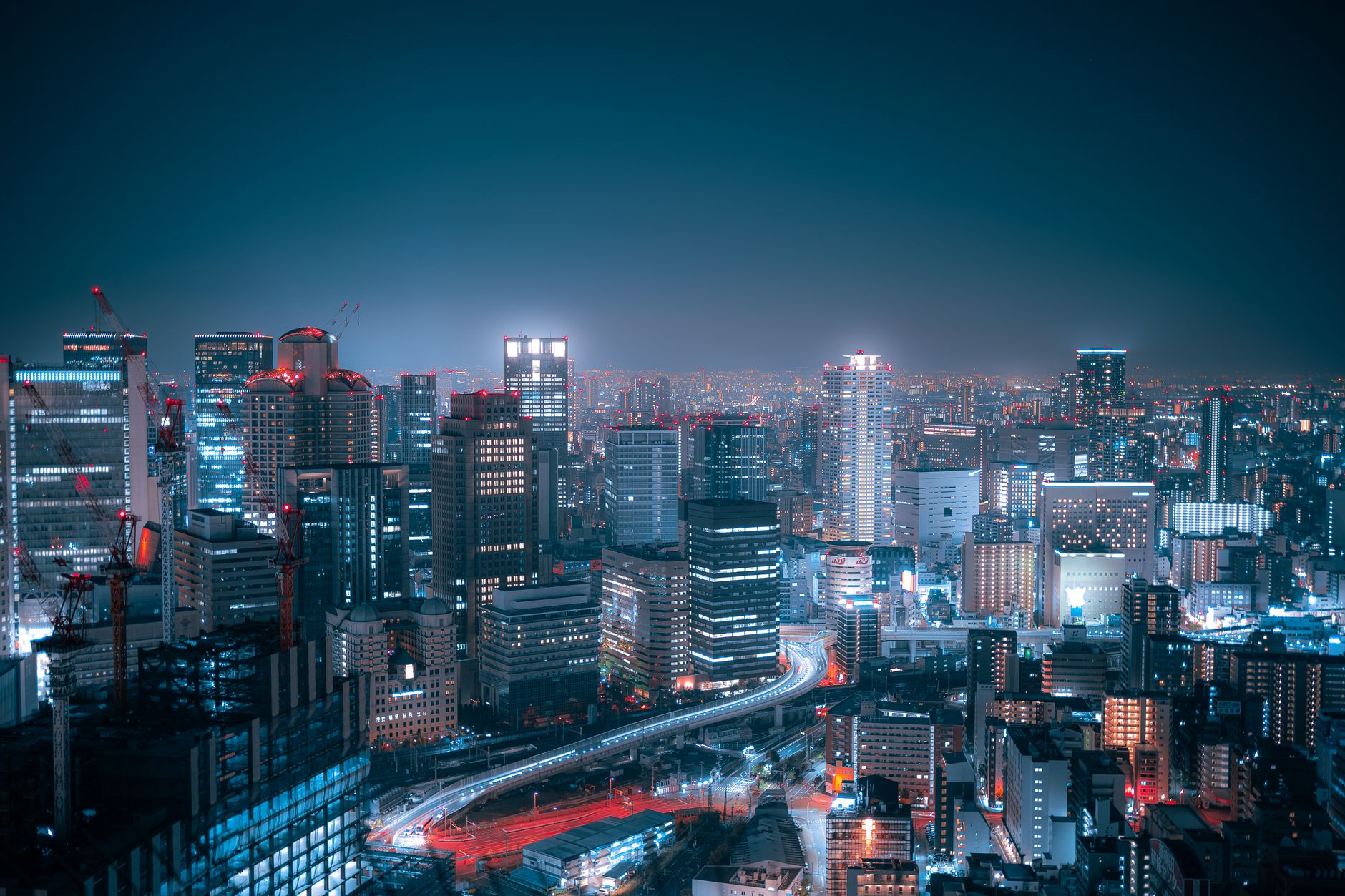 Stunning aerial view of Osaka's city lights and skyscrapers at night.